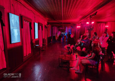Vampire Lounge guests watching haunted house video feeds