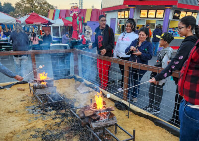 Family roasting marshmallows over fire