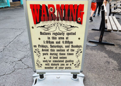 A sign warning guests of the loud noises and gunfire for the Texas Courthouse show