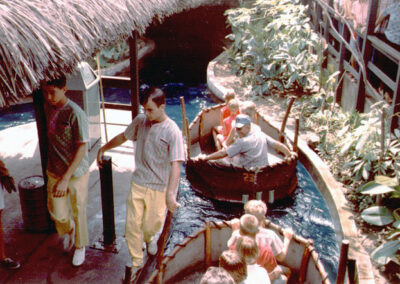 Boats leave the station of The Cave ride