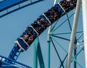 A fresh navy blue train with a retro Six Flags over Texas logo on the front