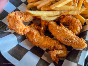 Hand-breaded chicken tenders with fries