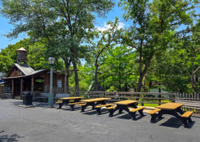 Picnic tables line an area that formerly housed a Coca Cola Freestyle shop