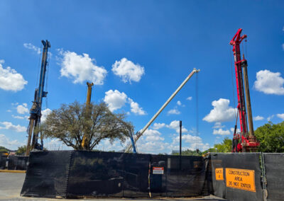 Machines drilling into the ground for support footers