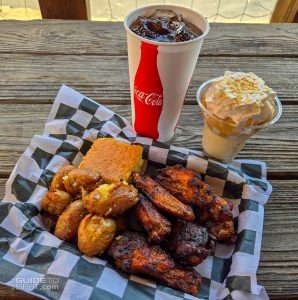 Smoked chicken wings with smashed potatoes, cornbread, and banana pudding from JB's Smokehouse