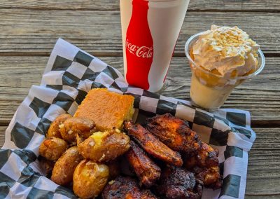 Smoked chicken wings with smashed potatoes, cornbread, and banana pudding from JB's Smokehouse
