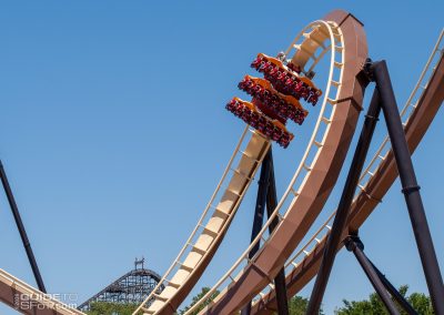 A test train speeds through the overbanked turn