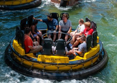 Six Flags Over Texas guests float toward the station on updated Roaring Rapids rafts