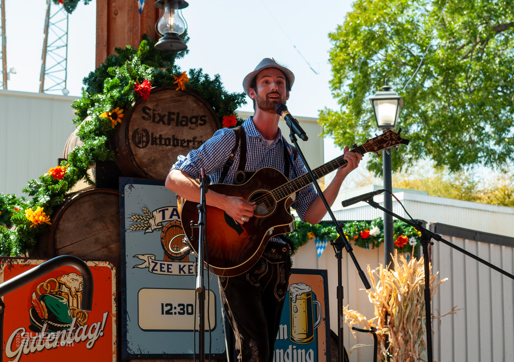 Gutentag! performer playing German folk tunes with a guitar during Oktoberfest