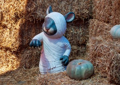 A mummy rat figurine hiding in the hay maze during Tricks and Treats